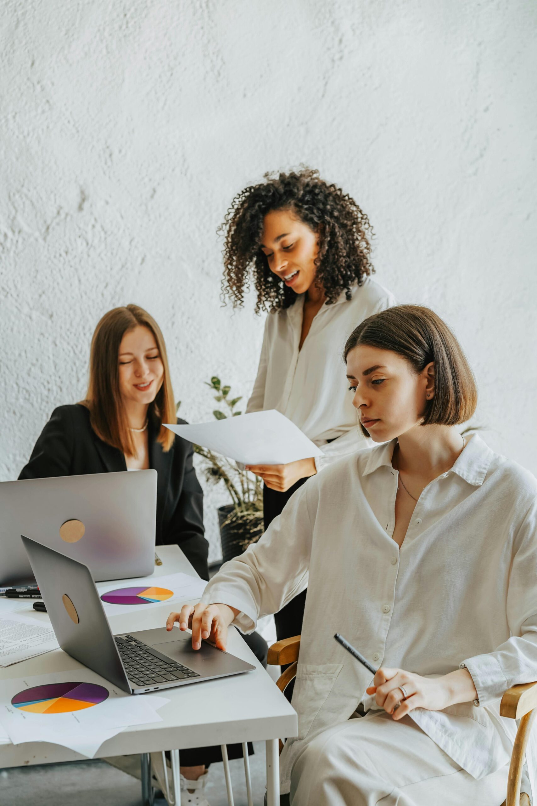 three women in office working