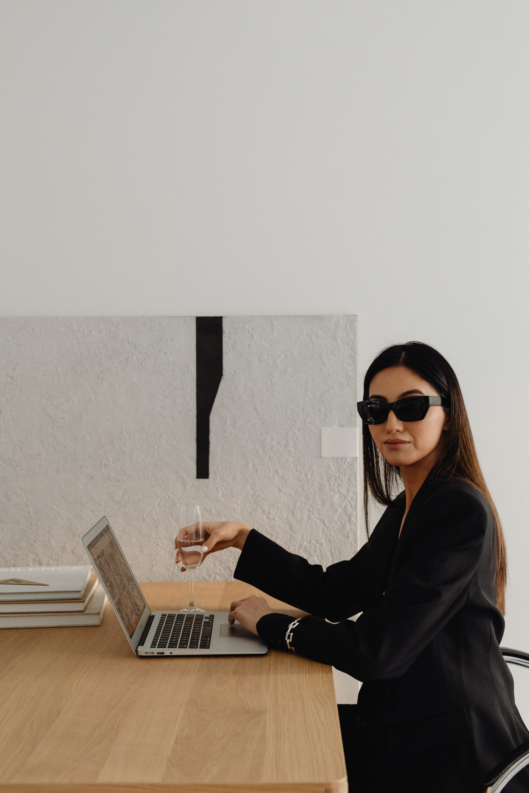 A hiring manager reviewing a job offer document at a desk, representing the moment compensation conversations happen too late in the hiring process.